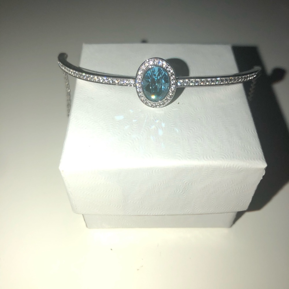 Silver bracelet with blue center gem